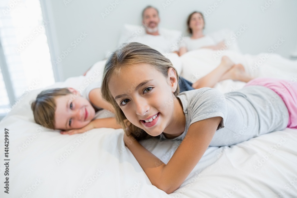 Portrait of smiling girl and boy lying on bed in bedroom Portrait of smiling girl and boy lying on bed in bedroom