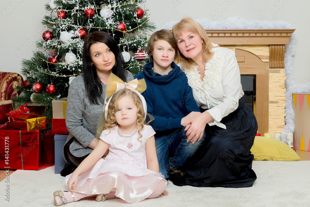 family of four people around a Christmas tree. family of four people around a Christmas tree.