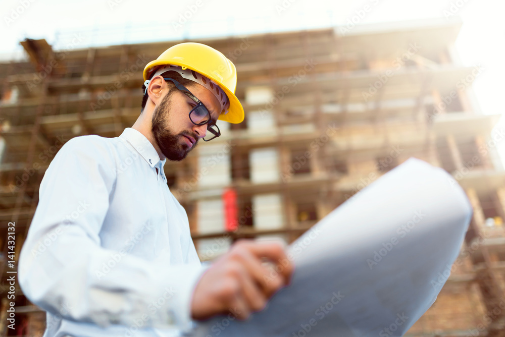Architect at Construction Site Checking Blueprints Architect at Construction Site Checking Blueprints