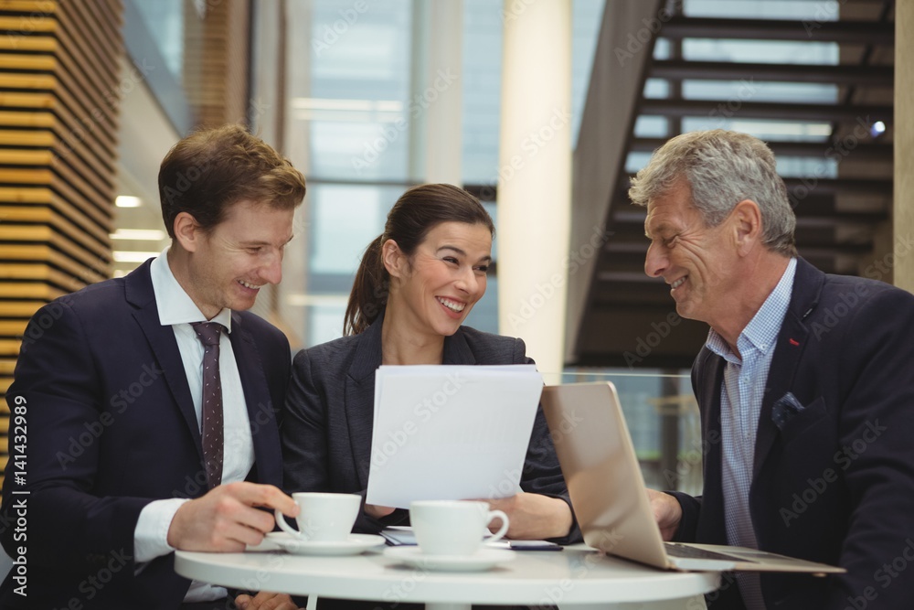 Businesspeople discussing over a paper document