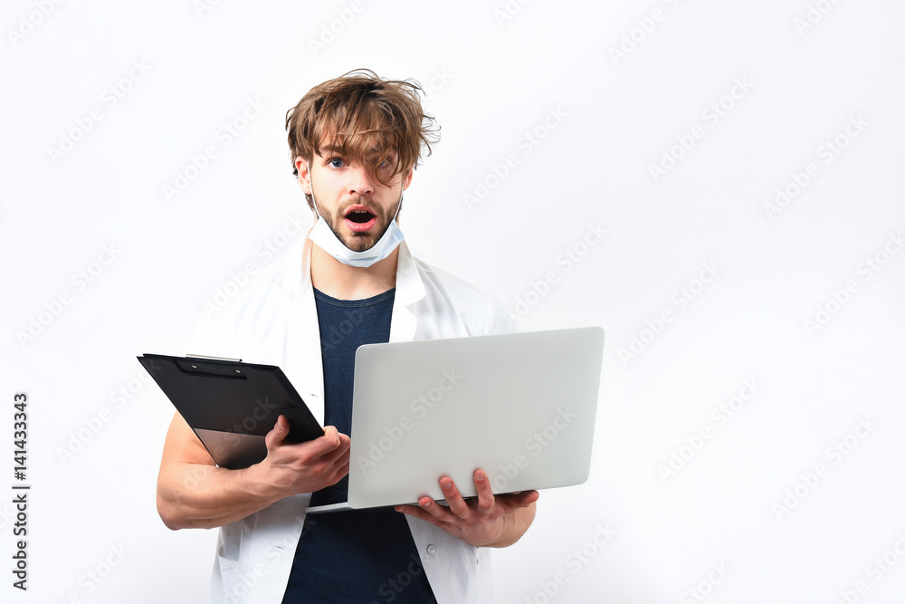 Bearded caucasian doctor or postgraduate student with laptop and clipboard Bearded caucasian doctor or postgraduate student with laptop and clipboard