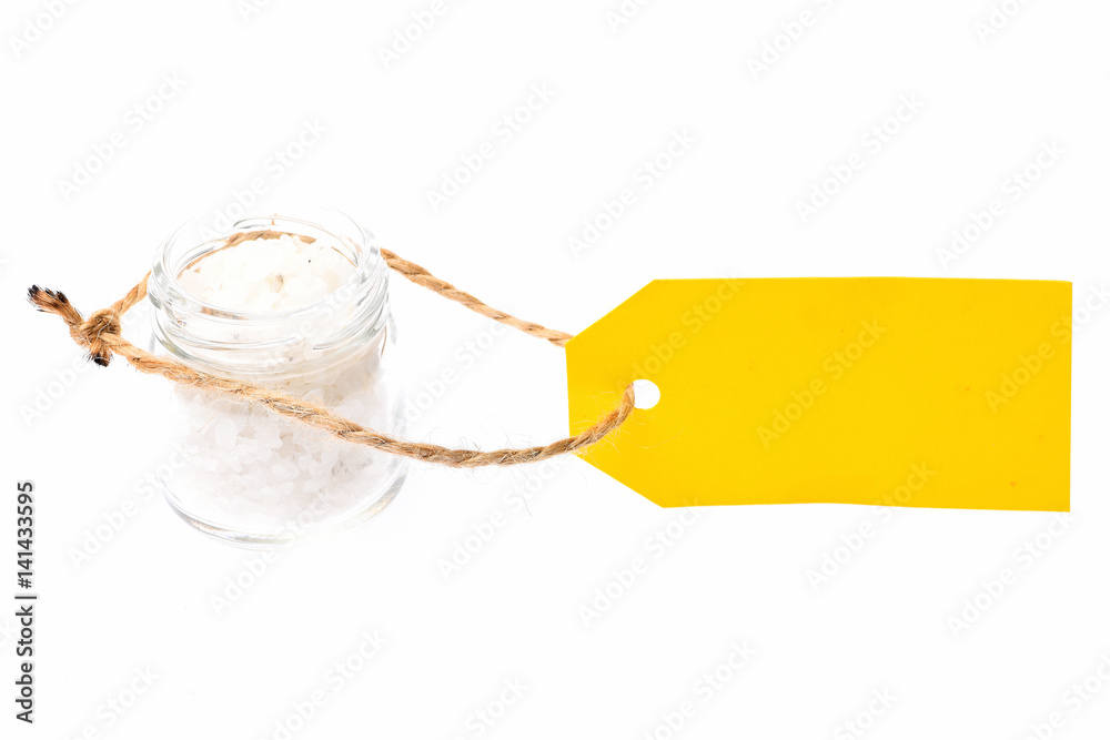 salt in glass jar, yellow tag isolated on white
