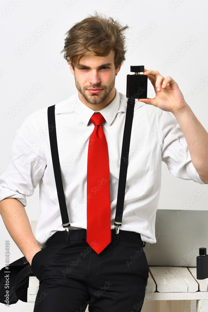Caucasian stylish man posing with perfume Caucasian stylish man posing with perfume