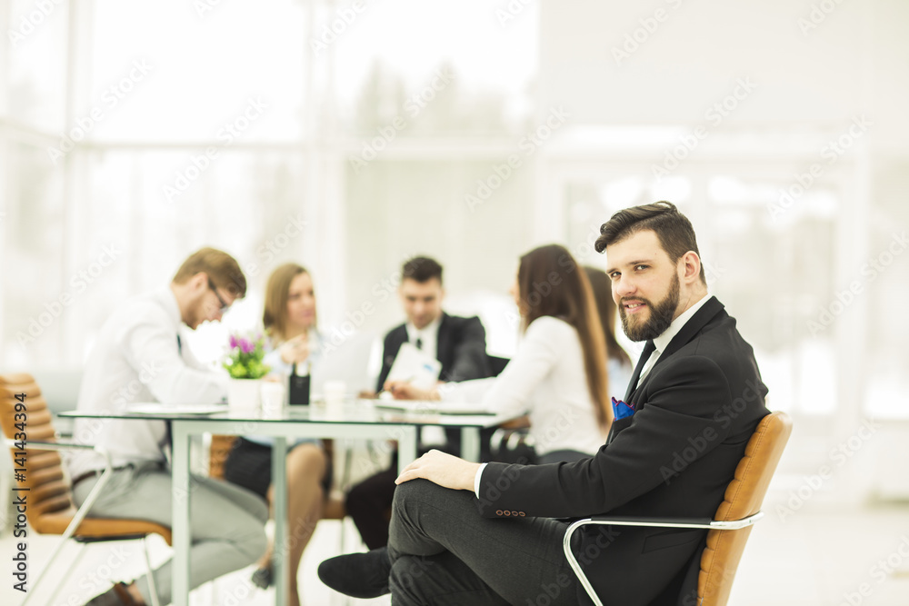 Manager of the company on the background of the working meeting the business team Manager of the company on the background of the working meeting the business team