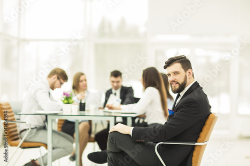  Manager of the company on the background of the working meeting the business team