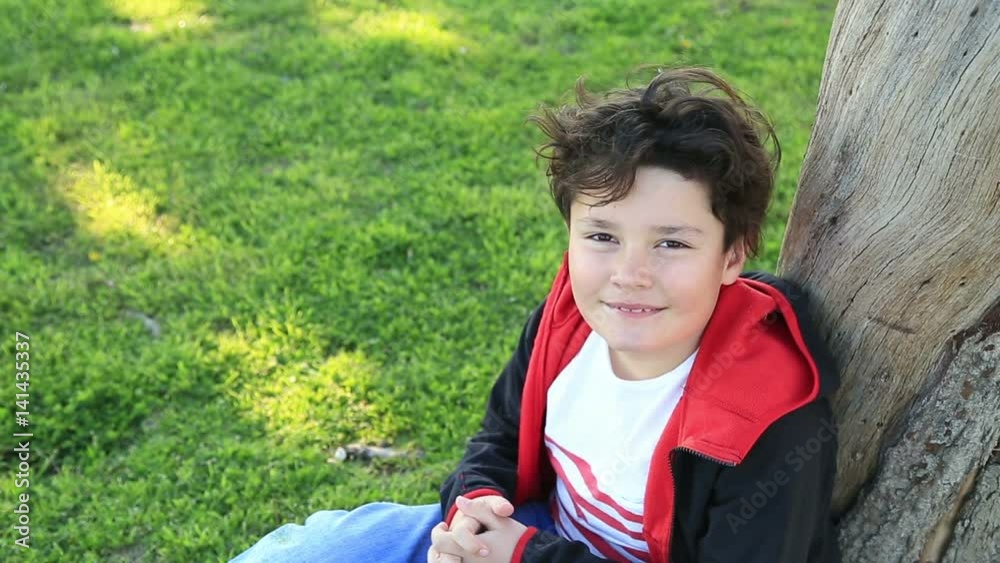 Portrait of young happy teen boy looking at camera and smiling at the outdoors Portrait of young happy teen boy looking at camera and smiling at the outdoors
