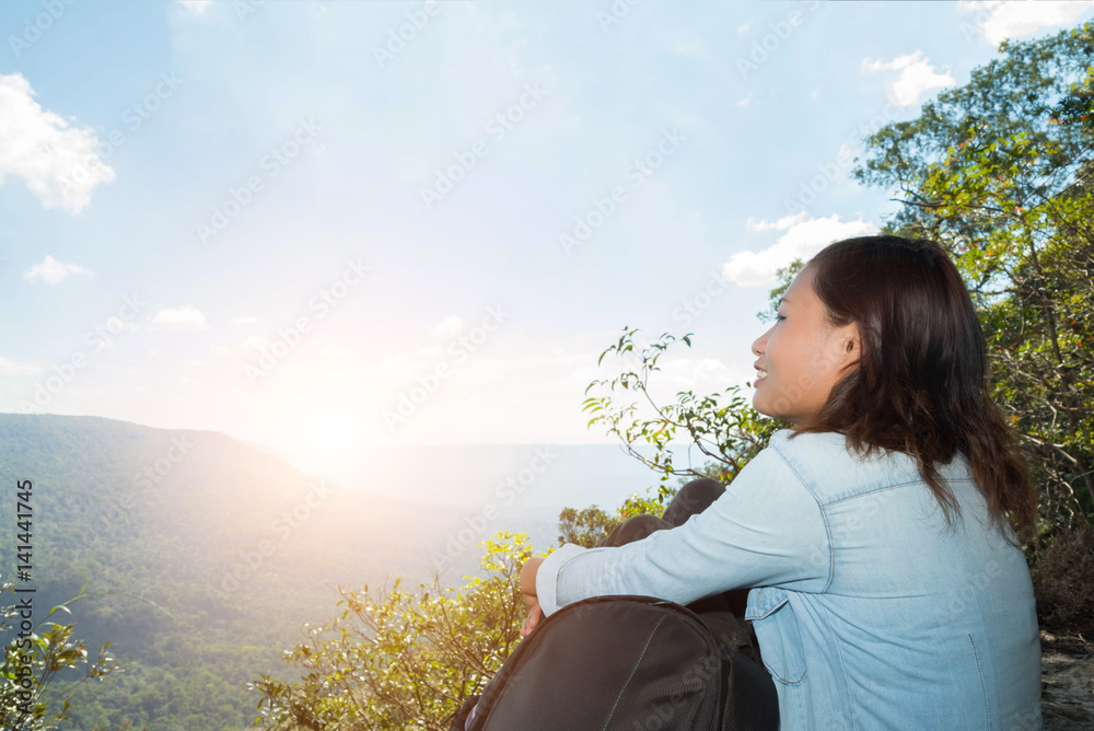 woman hiking sit down enjoy the beautiful view at mountain for sun light woman hiking sit down enjoy the beautiful view at mountain for sun light