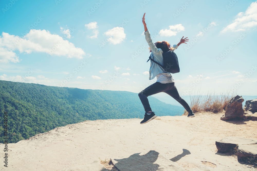 young woman Jumping at mountain view for sun light young woman Jumping at mountain view for sun light