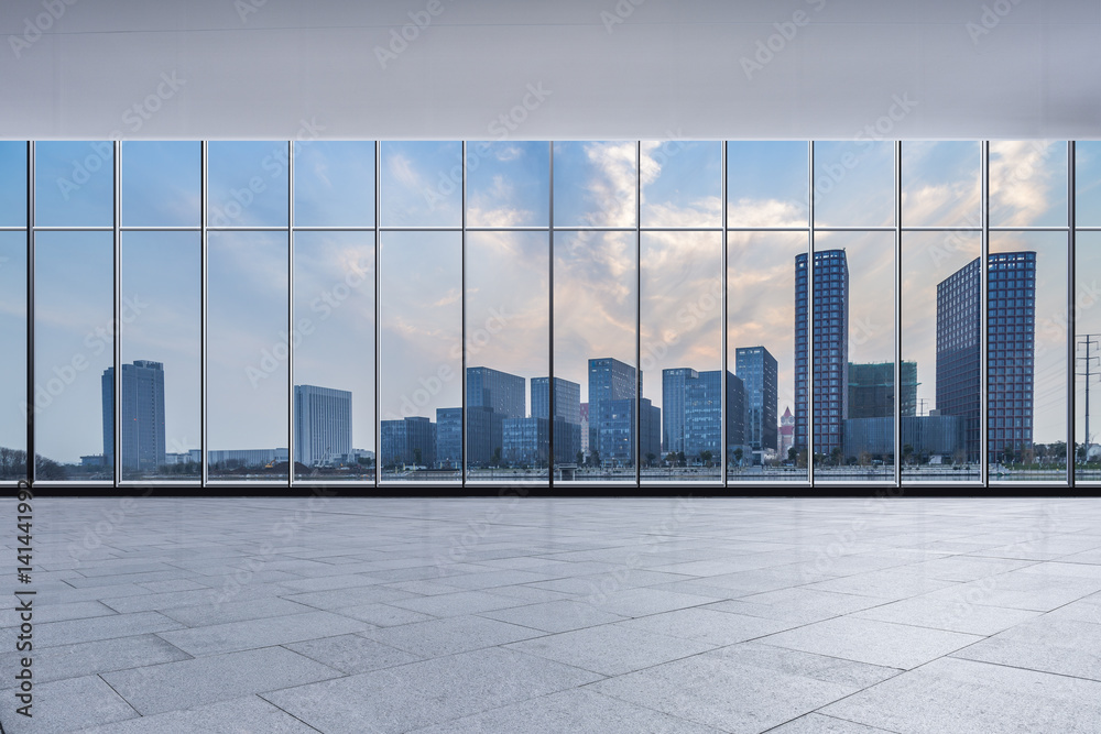 Fototapeta premium The modern office buildings from glass window