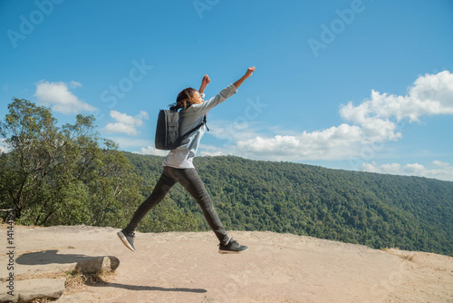 young woman Jumping at mountain view for sun light