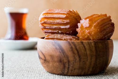 Turkish Dessert Tulumba tatlisi with tea. photo