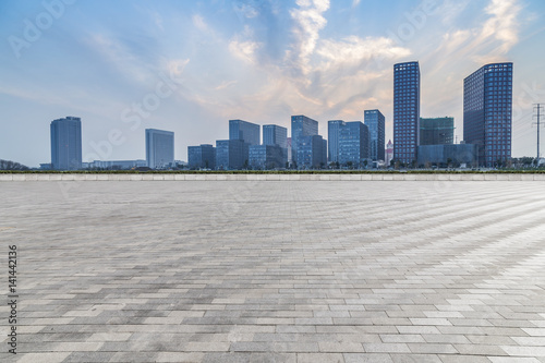skyline and modern business office buildings with empty concrete square floor © MyCreative