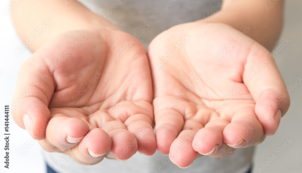 Close up outstretched cupped hands of young woman selective focus Close up outstretched cupped hands of young woman selective focus
