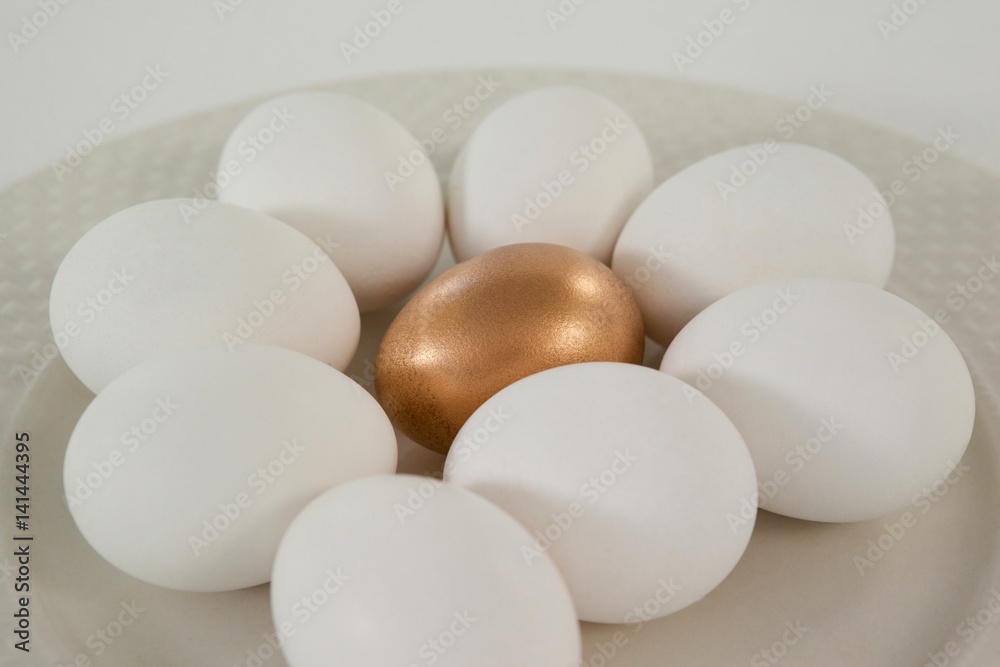 White and golden easter eggs in plate White and golden easter eggs in plate