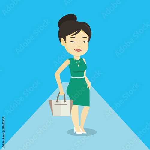 Woman posing on catwalk during fashion show.