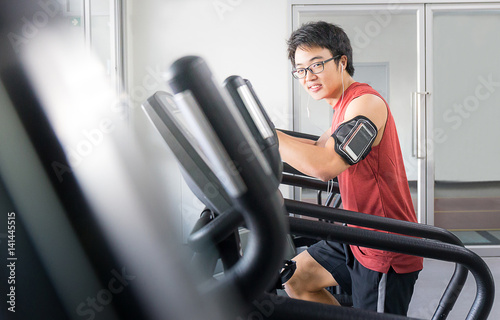 handsome man on running machine in gym, fitness room