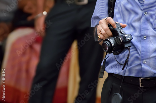 Photographer holding camera.