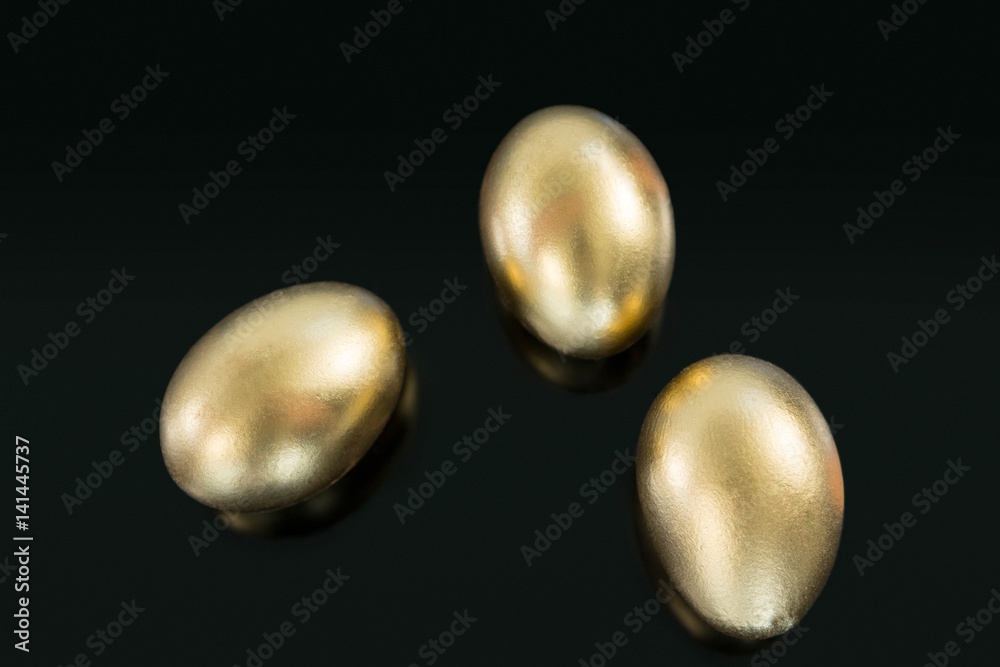 Golden Easter eggs on black background Golden Easter eggs on black background