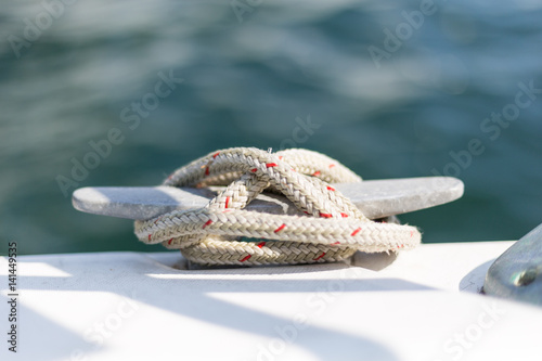 Cleat with line on the sailboat. Knot. Boat detailas