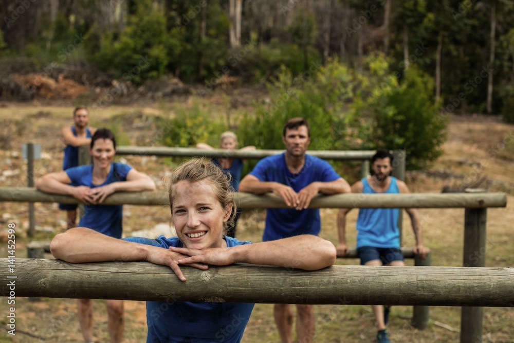 Fototapeta premium Group of people leaning on hurdles during obstacle training