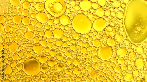 Moving oil globules on water colorful background