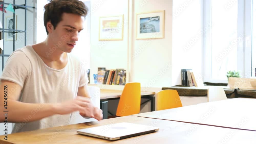 Designer Coming to Work, Starts Work on Laptop Designer Coming to Work, Starts Work on Laptop