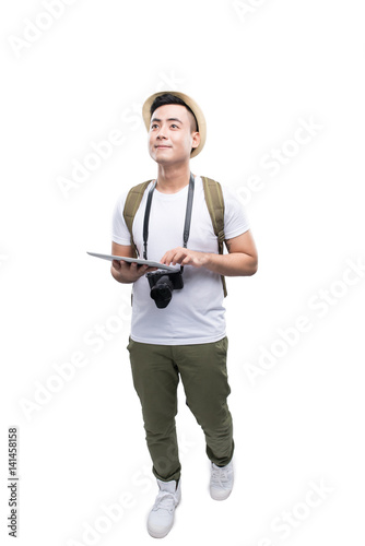 Full length portrait of happy tourist man using tablet on white background