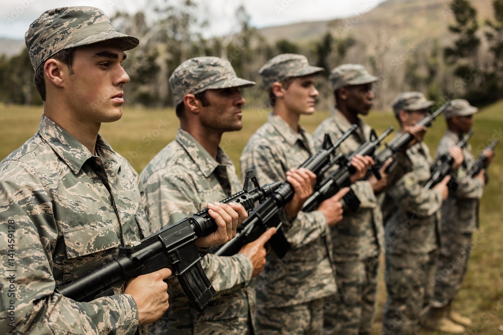 Group of military soldiers standing with rifles Group of military soldiers standing with rifles