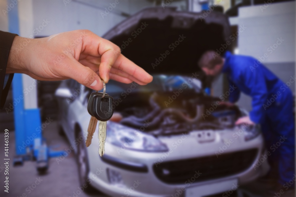 Composite image of happy woman receiving car keys Composite image of happy woman receiving car keys