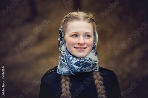 Big portrait of beautiful red-haired girl in scarf photo