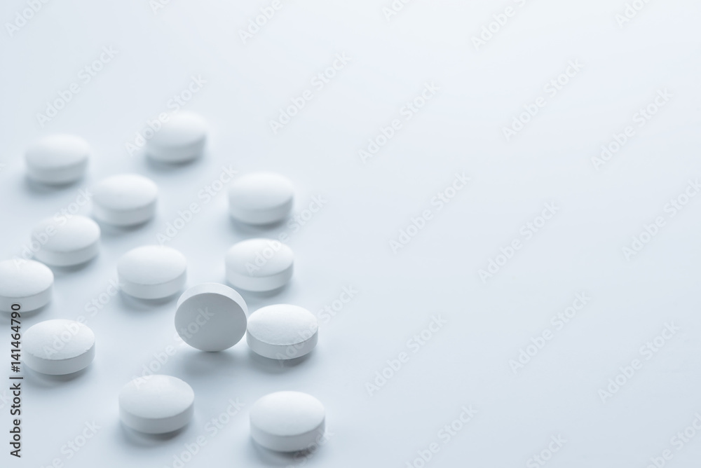 Medical,pharmacy theme background concept.White pills on white background.