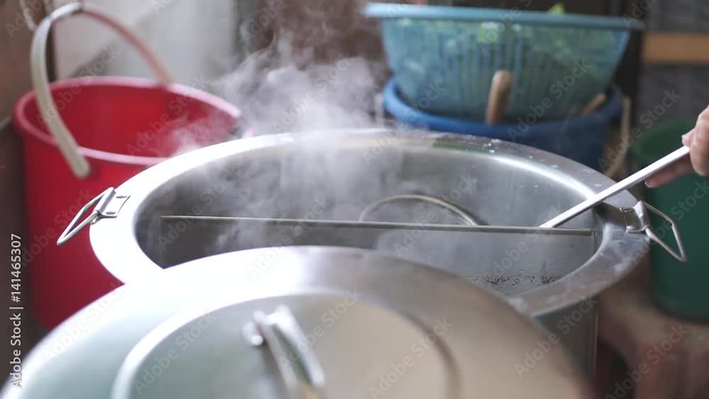 Boiling noodle in stainless steel pot with green vegetable Boiling noodle in stainless steel pot with green vegetable