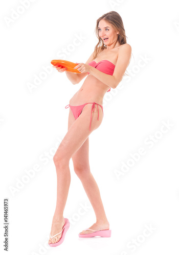 Happy young woman in a bikini with flying disc, isolated on white background