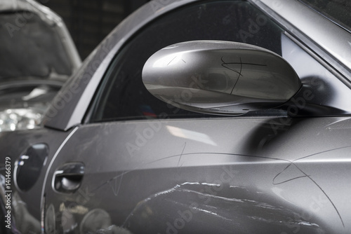 Auto body repair series   Closeup of damaged grey sport car with scratches