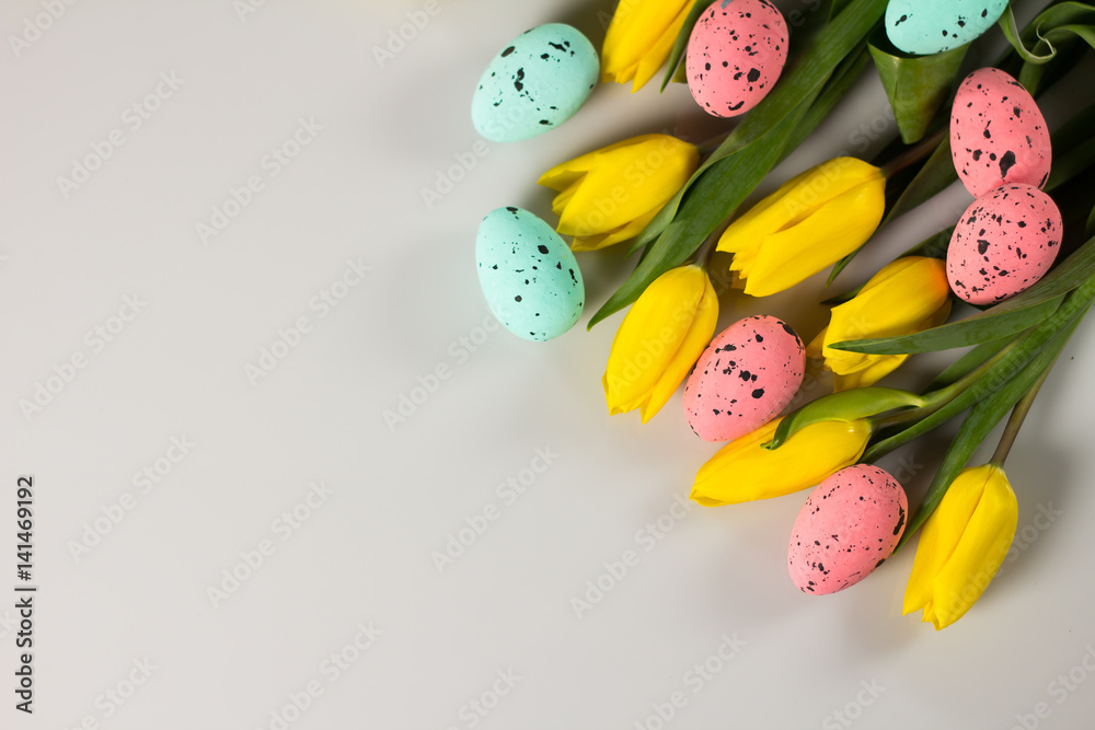Easter theme. Eggs with tulips on wooden board, easter holiday concept. Copyspace for text.
