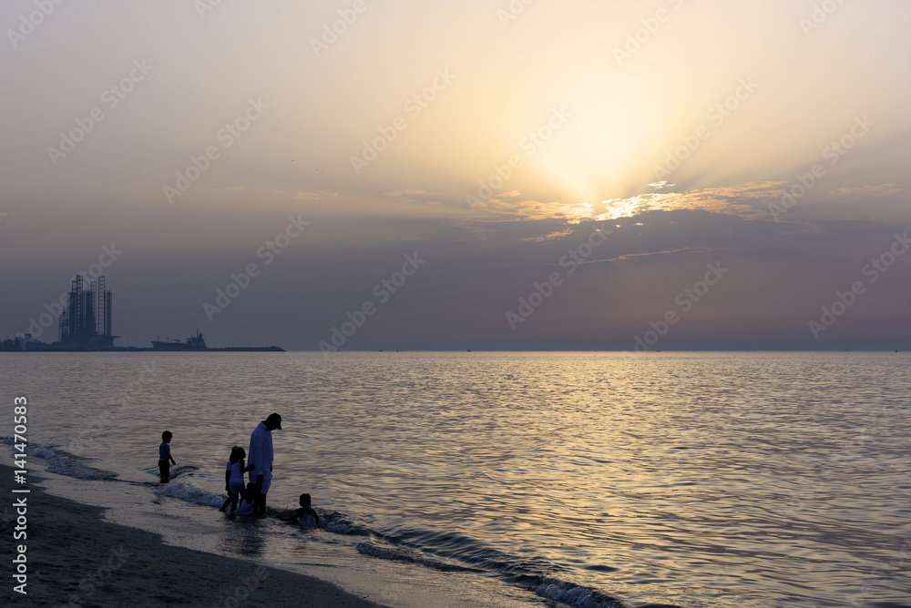 Kids playing with father in Beach