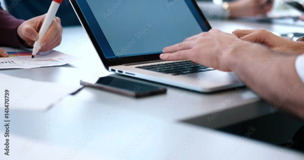 hands typing on laptop computer keyboard in office hands typing on laptop computer keyboard in office