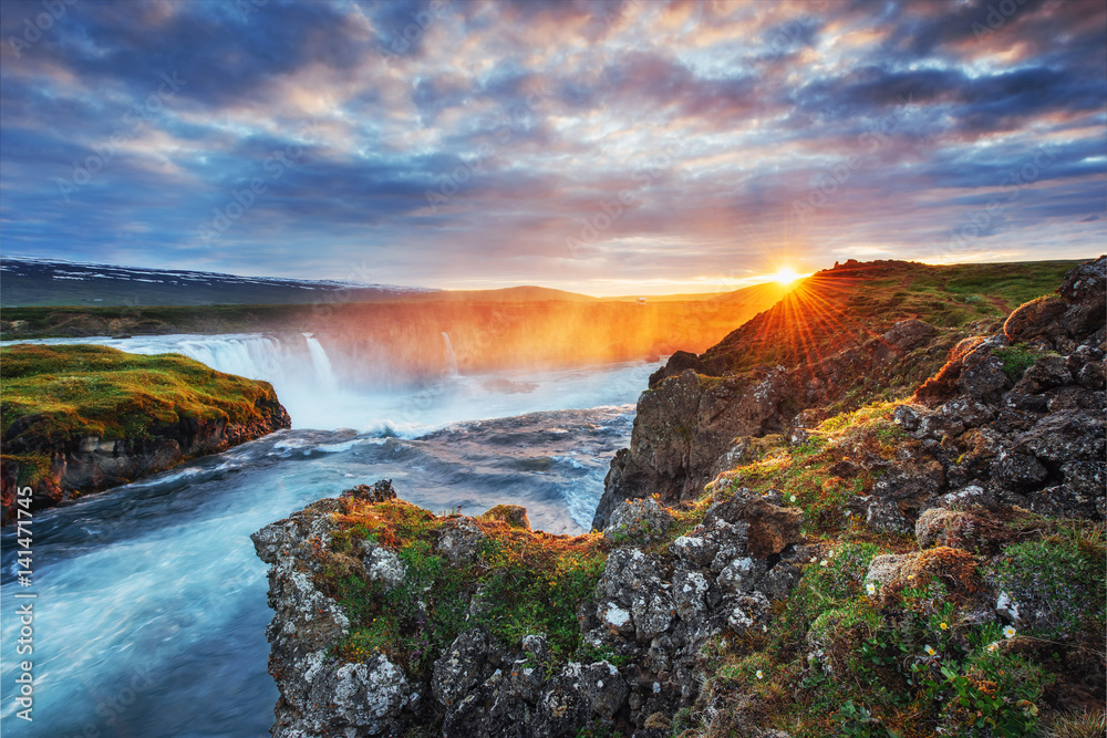 Godafoss waterfall at sunset. Fantastic landscape. Beautiful cumulus clouds. Iceland Europe