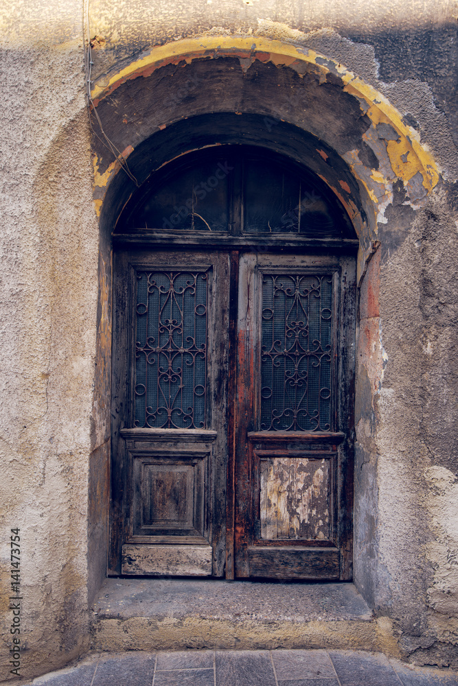 Old weathered wooden door, closed house entrance