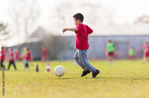 Kids soccer football - children player match on soccer field