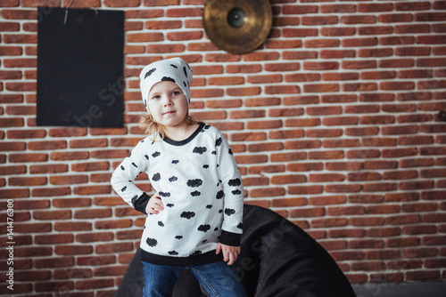 Child in soft warm pajama playing in bed photo