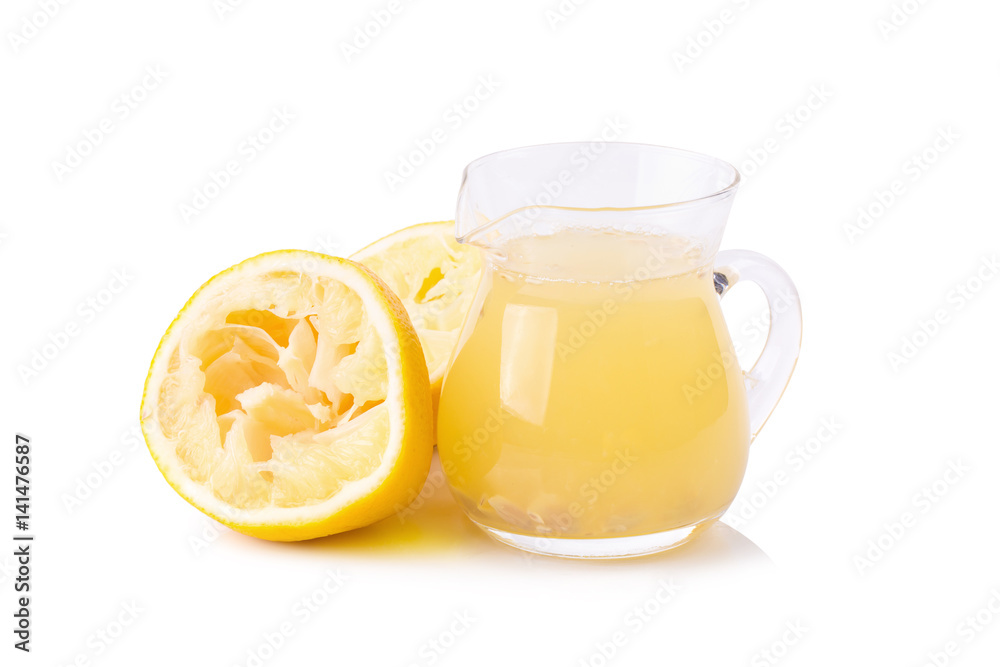 glass bowl of freshly squeezed lemon juice, lemon squeezer and ripe lemons on white background glass bowl of freshly squeezed lemon juice, lemon squeezer and ripe lemons on white background
