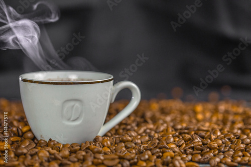 Coffee cup and coffee beans on table.