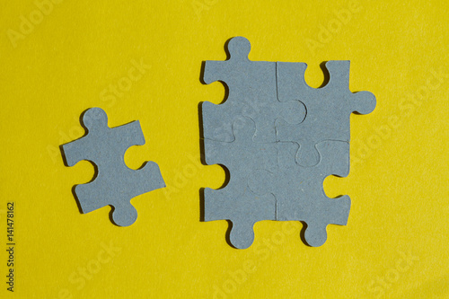 Jigsaw Puzzle pieces on yellow background