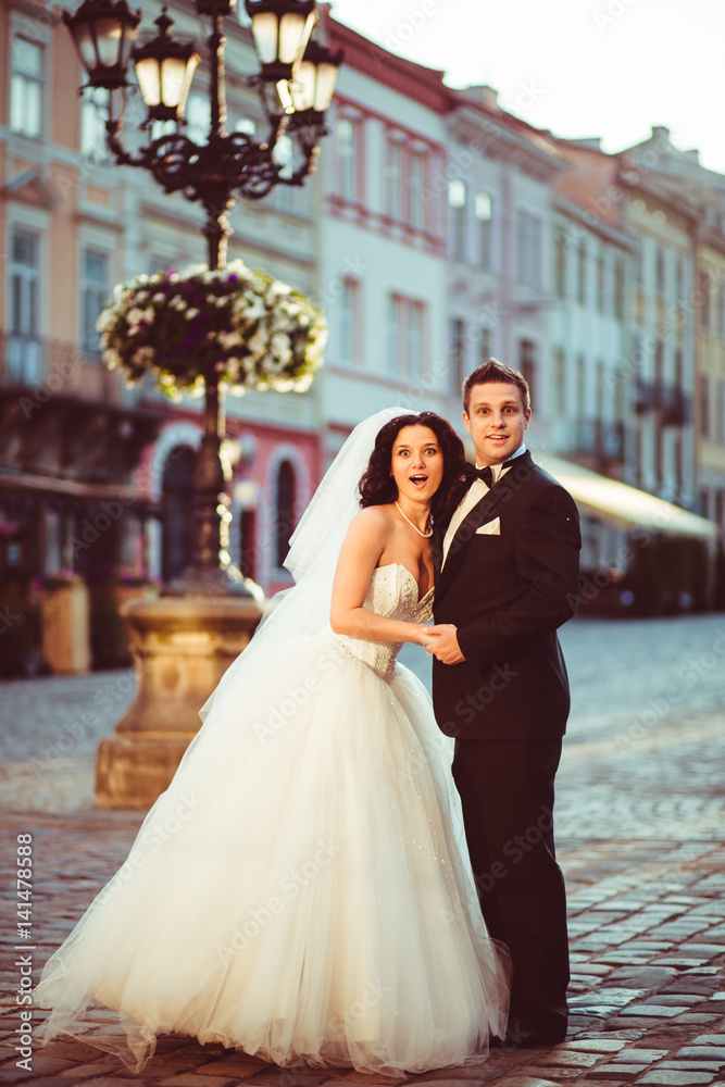 The charming brides embracing in the center of square The charming brides embracing in the center of square