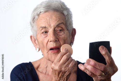 Senior woman make-up face on white background © curto