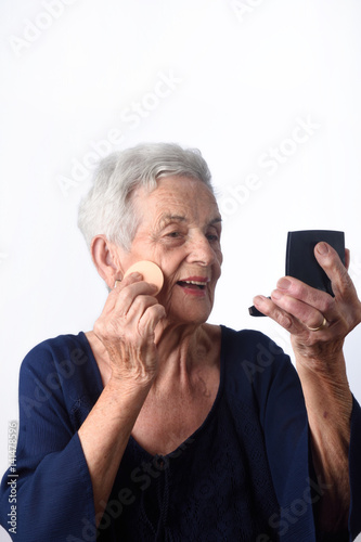 Senior woman make-up face on white background photo