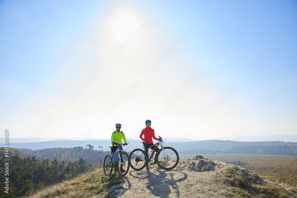 Mountain bikers training at the hillside. A group of female mountain bikers making their way across a rocky hillside.