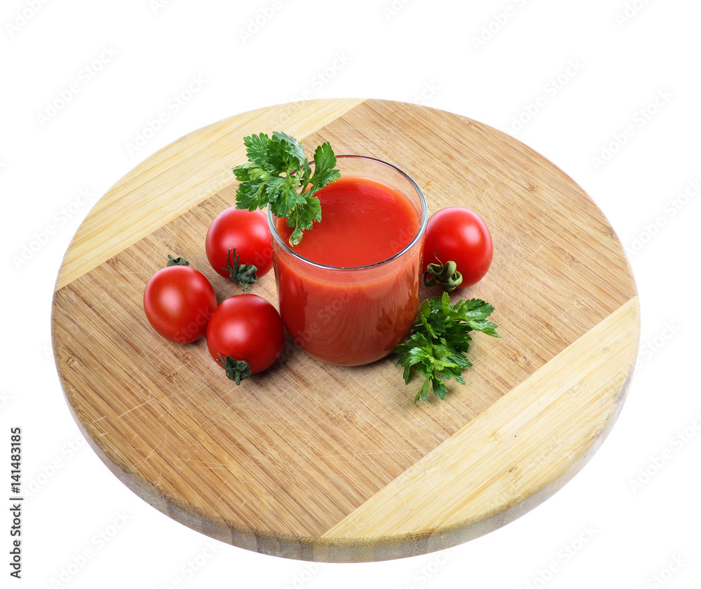 glass full of freshly prepared tomato juice on wooden board against white background.