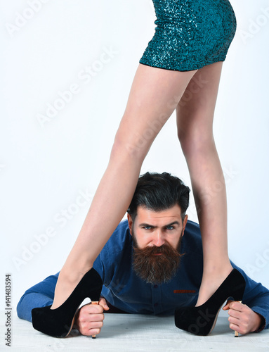bearded man with sexy female legs has serious face